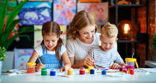 Mother And Children Son  And Daughter Painting Draws In Creativity In Kindergarten