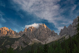 Fototapeta Góry - The last rays of the setting sun illuminate the peaks of the Friulian Dolomites, near the Rifugio Giaff, in Friuli, Italy.