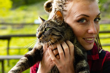 Loving Young Woman Cuddling Her Cat To Her Cheek