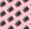 © Darya Lavinskaya - Seamless pattern with vintage instant camera at pastel pink background.