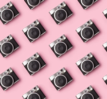 Seamless Pattern With Vintage Instant Camera At Pastel Pink Background.