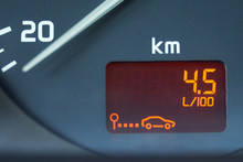 On-board Computer Of A Car Shows A Low Petroleum Consumption. The Figures On The Dashboard Show The Fuel Consumption Of 4.5 Liters Per 100 Kilometers