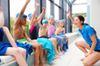 © Monkey Business - Female Coach Giving Children In Swimming Class Briefing As They Sit On Edge Of Indoor Pool