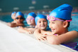 © Monkey Business - Group Of Children In Water At Edge Of Pool Waiting For Swimming Lesson
