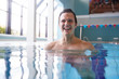© Monkey Business - Portrait Of Male Swimmer Warming Up In Swimming Pool