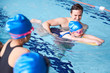 © Monkey Business - Male Coach In Water Giving Group Of Children Swimming Lesson In Indoor Pool