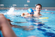 © Monkey Business - Male Coach In Water Giving Group Of Children Swimming Lesson In Indoor Pool