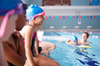 © Monkey Business - Male Coach In Water Giving Group Of Children Swimming Lesson In Indoor Pool