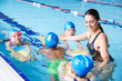 © Monkey Business - Female Coach In Water Giving Group Of Children Swimming Lesson In Indoor Pool