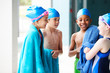 © Monkey Business - Group Of Children Wearing Towels On Edge Of Swimming Pool After Lesson