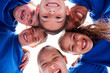 © Monkey Business - Low Angle View Looking Up Into Faces Of Children In Huddle On Sports Day
