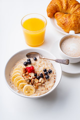 Wall Mural - Breakfast with oatmeal with berries and nuts, coffee and orange juice