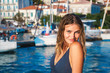 © IrynaV - Young happy woman feels fun on the luxury sail boat yacht catamaran in turquoise sea in summer holidays.