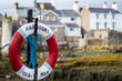 A lifebuoy, ring buoy, lifering, lifesaver, life donut, life preserver or lifebelt is a life saving buoy. Castletown Harbour, Isle of Man. Copy space.