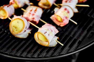 Wall Mural - Grilled potato with bacon on gas grill . Grilled food. Barbecue. Copy space. Healthy food.