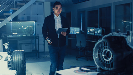 Poster - Development Laboratory Room with Professional Automotive Design Engineer Working on a Electric Car Chassis with Wheels, Batteries, Engine and Suspension. 