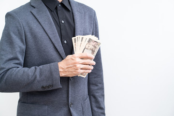 Unrecognize businessman with ten thousand Yen banknote