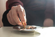 Closeup of male hand putting out a cigarette in an ashtray