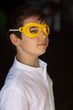 © Westend61 - Boy wearing yellow eye mask, looking at camera