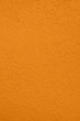 Saturated dark yellow colored low contrast Concrete textured background with roughness and irregularities. Autumn Winter 2020 color trend.