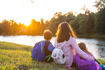 woman and two children from back.