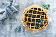 Traditional homemade american blueberry pie with lattice pastry, top view.
