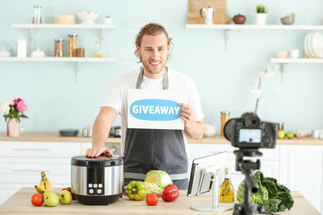 Wall Mural - Food blogger announcing prize drawing while recording video in kitchen