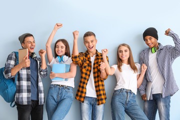 portrait of happy young students on color background