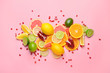 Different sliced citrus fruits on color background