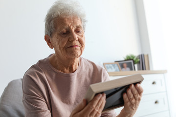 Sticker - Elderly woman with framed photo at home