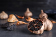 Aged black garlic on table. Space for text