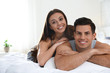 © New Africa - Portrait of lovely couple resting on large bed