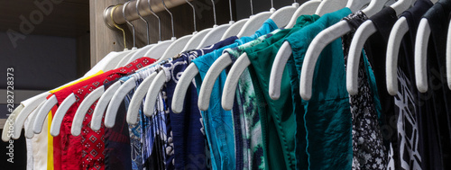 Cuadros en Lienzo An organized closet of colorful shirts depicting order.