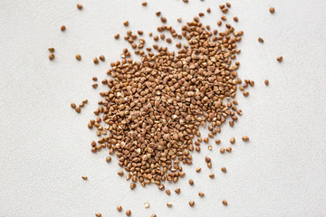 Wall Mural - Pile of buckwheat isolated on white background. Top view.