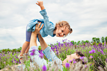 Happy family father and daughter having fun in lavender field