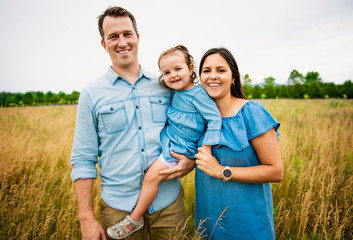 Portrait of a happy young family in the countryside