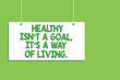 Handwriting text Healthy Isn t not A Goal, It s is A Way Of Living.. Concept meaning Create good habits routines Hanging board message communication open close sign green background