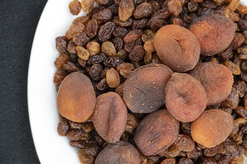 Wall Mural - close-up of yellow seedless raisins and day dried apricots, on a plate