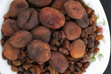 Wall Mural - close-up of yellow seedless raisins and day dried apricots, on a plate