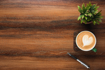 Aufkleber - Wood office desk table with cup of coffee, pen and plant pot. Top view with copy space, flat, lay.