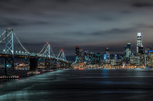 San Francisco -Oakland Bay Bridge And San Francisco Skyline Aglow At Night