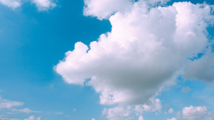 Beautiful bright blue sky with white fluffy clouds on a clear sunny day. Royalty high-quality free stock photo image of blue sky with white cloud, nice weather. Photo of natural cloudscape background