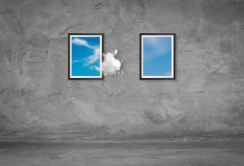 Wall Mural - abstract image of white clouds floating out from picture frame go to another frame on concrete wall.