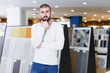 © JackF - Portrait of man customer choosing ceramic tile  in shop