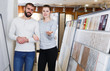 © JackF - Smiling family couple standing near ceramic  tile in shop
