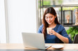 © chayathon2000 - Asian business girl working and drinking coffee in cafe