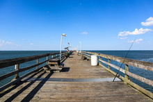 A Lone Fishing Pole Rests On The Ocean View Fishing Pier In Norfolk, Virginia.