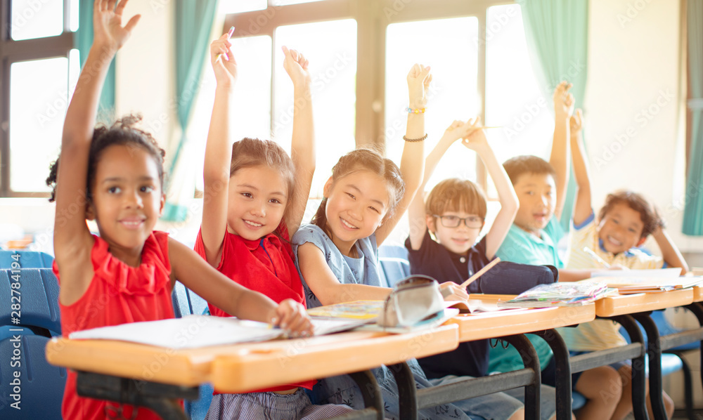 Smiling elementary school kids in classroom Stock Photo | Adobe Stock