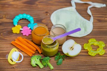 Wall Mural - Baby food. Mashed vegetables and fruits in jars. Selective focus.