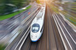 © aapsky - Railroad travel high speed fast train passenger locomotive motion blur effect in the city, top aerial view from above.